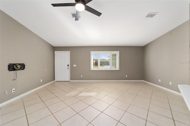 spare room featuring ceiling fan and light tile patterned floors