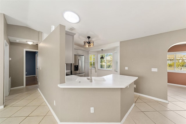 kitchen with a wealth of natural light, gray cabinets, sink, and stainless steel refrigerator with ice dispenser