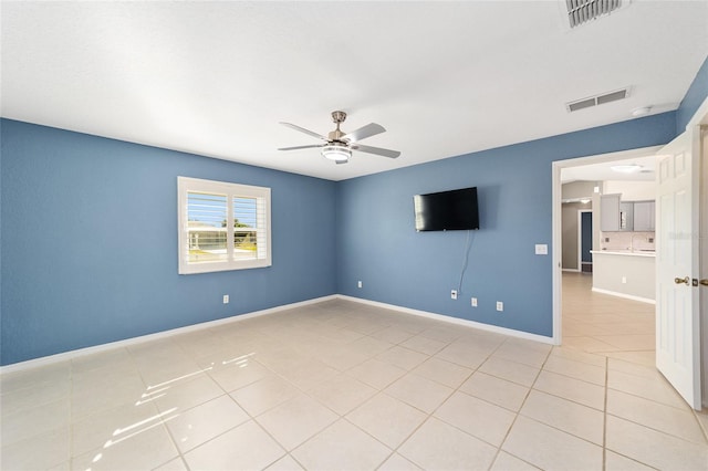 unfurnished room with ceiling fan and light tile patterned flooring