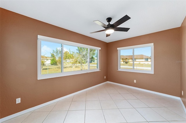 unfurnished room featuring light tile patterned floors and ceiling fan