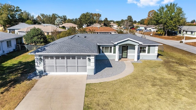 single story home featuring a front yard and a garage