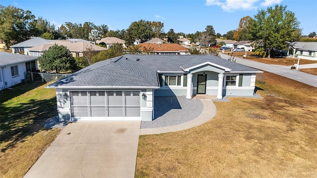 single story home with a garage and a front lawn