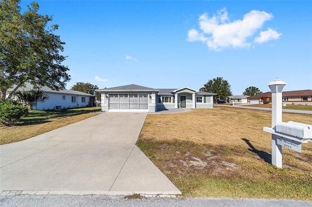 single story home featuring a garage and a front lawn