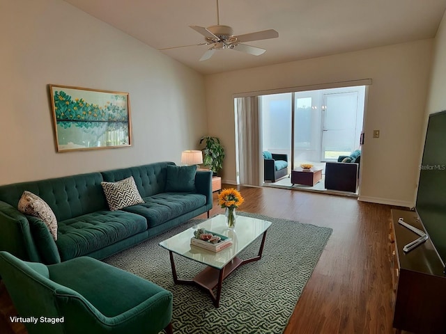 living room featuring ceiling fan, hardwood / wood-style floors, and vaulted ceiling