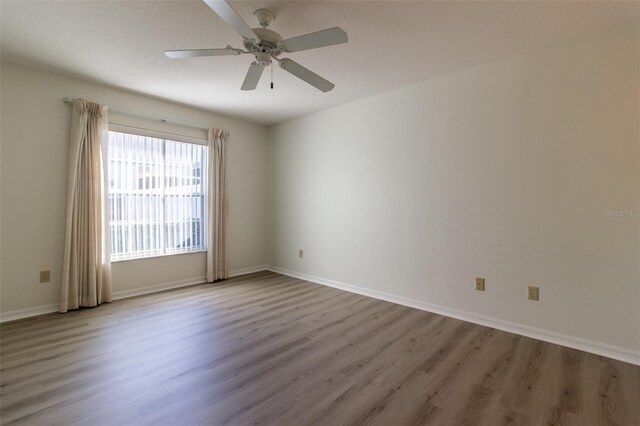 spare room featuring ceiling fan and light hardwood / wood-style floors