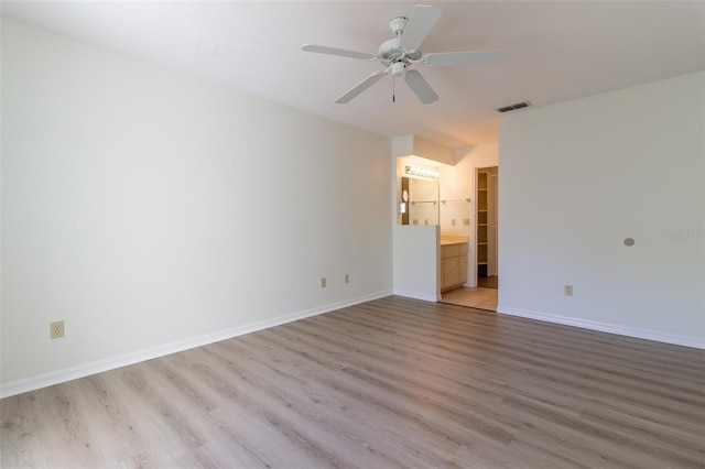 empty room featuring ceiling fan and light hardwood / wood-style floors