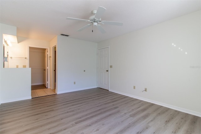 empty room featuring light hardwood / wood-style flooring and ceiling fan