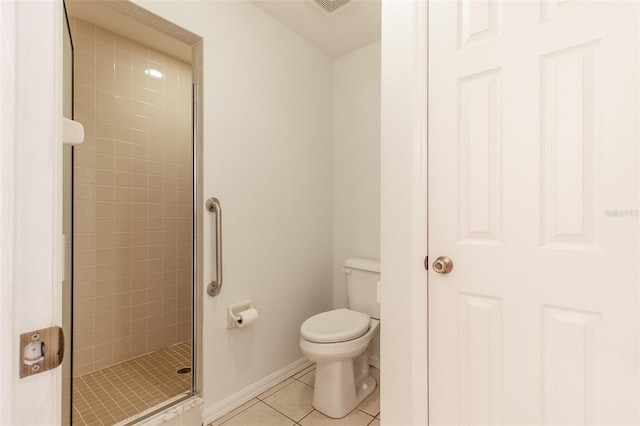 bathroom with toilet, a shower with shower door, and tile patterned flooring