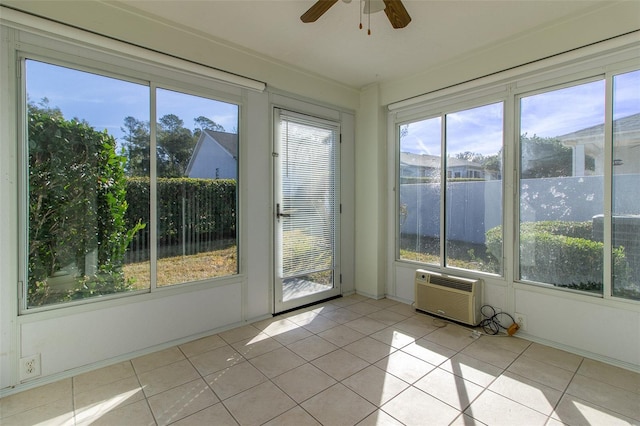 unfurnished sunroom featuring a wall mounted AC and ceiling fan