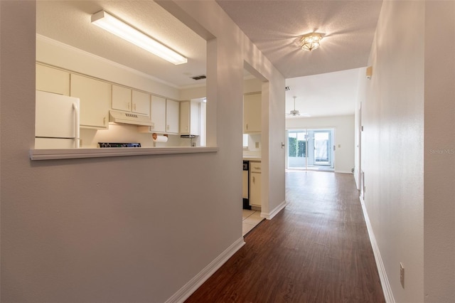 hallway featuring a textured ceiling and light wood-type flooring