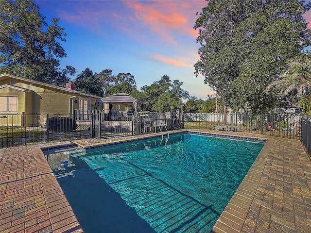 view of pool at dusk