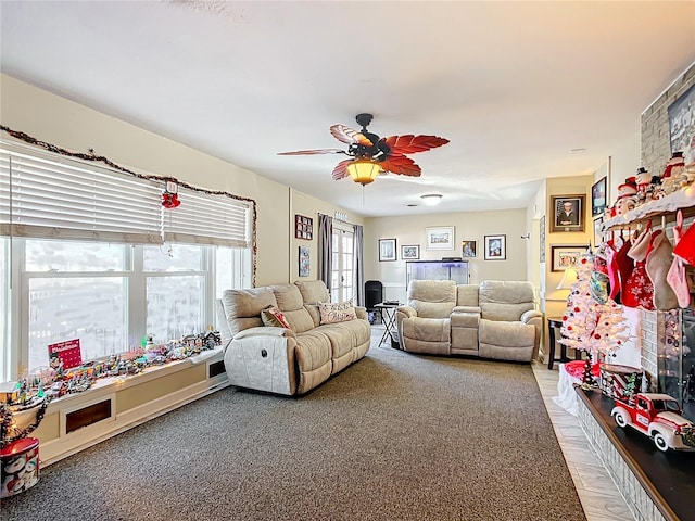 carpeted living room with ceiling fan