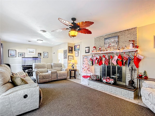 living room with a fireplace, carpet, and ceiling fan