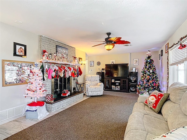 carpeted living room featuring ceiling fan and a brick fireplace