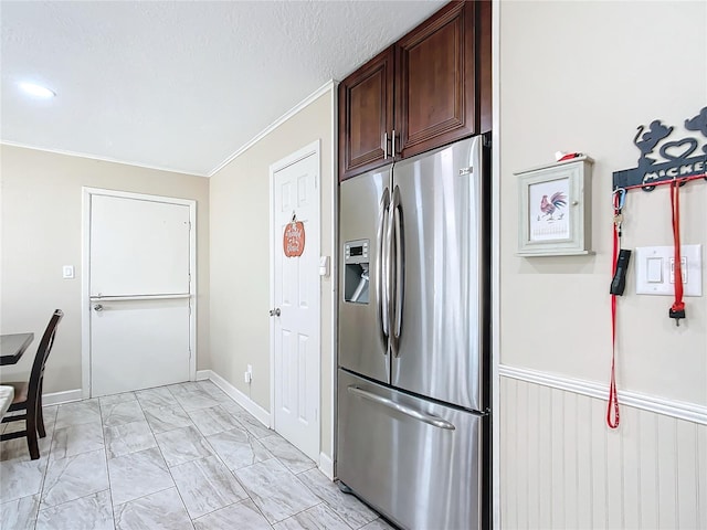 kitchen featuring a textured ceiling, dark brown cabinetry, stainless steel fridge with ice dispenser, and ornamental molding