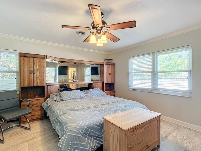 bedroom with a textured ceiling, ceiling fan, and ornamental molding