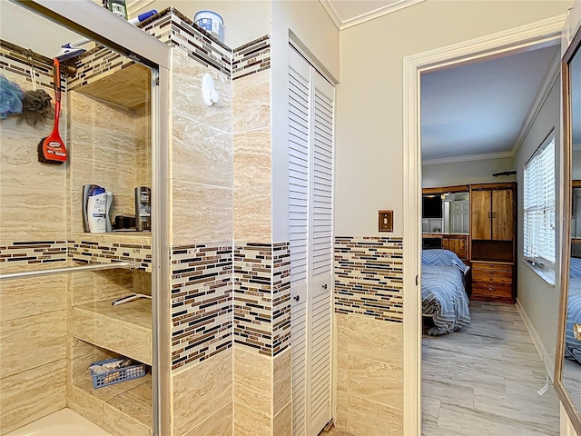 bathroom with ornamental molding and tile walls