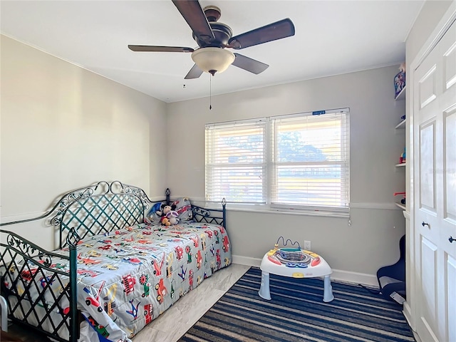 bedroom featuring ceiling fan and a closet