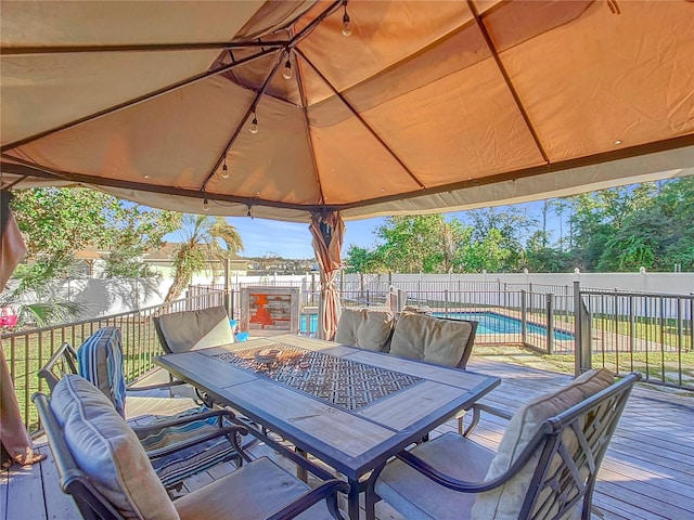 wooden terrace featuring a fenced in pool