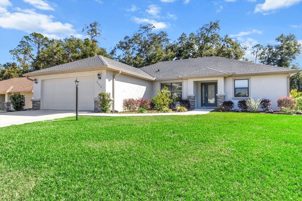 single story home featuring a front yard and a garage