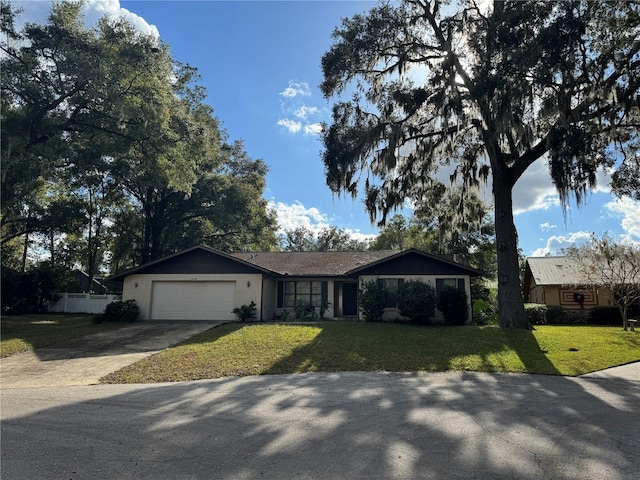 single story home featuring a garage and a front lawn