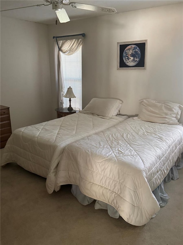 bedroom featuring ceiling fan and carpet