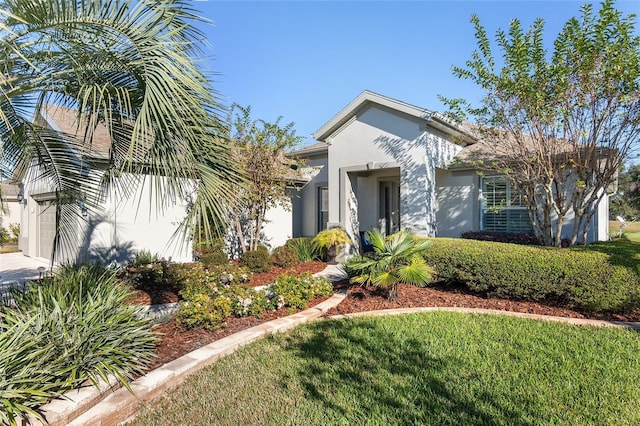 view of front of property with a front yard and a garage