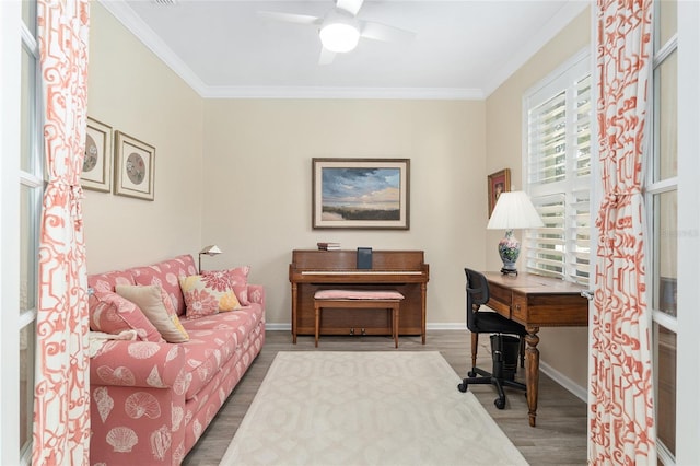 office featuring hardwood / wood-style floors, ceiling fan, and crown molding