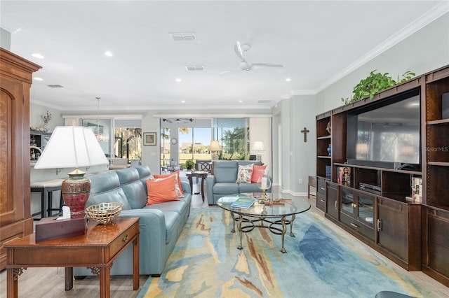 living room featuring light wood-type flooring, ceiling fan, and crown molding