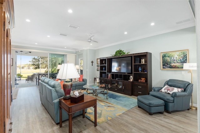 living room featuring light hardwood / wood-style floors, ceiling fan, and crown molding