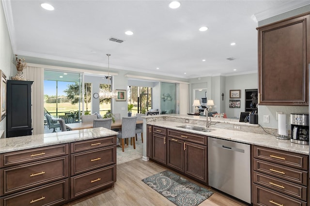 kitchen with kitchen peninsula, a wealth of natural light, dishwasher, and sink