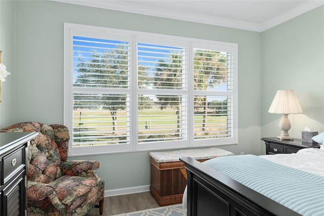 bedroom featuring light wood-type flooring and crown molding