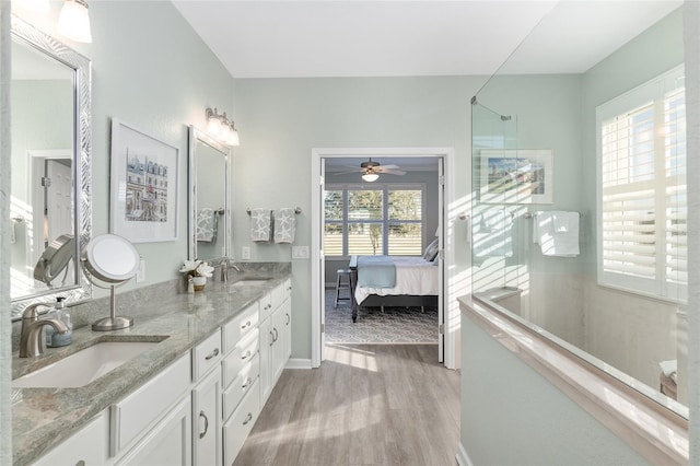 bathroom with hardwood / wood-style flooring, vanity, and ceiling fan