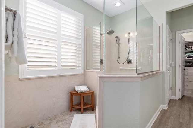 bathroom featuring a tile shower and hardwood / wood-style flooring