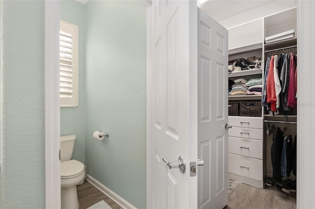 bathroom featuring hardwood / wood-style floors and toilet