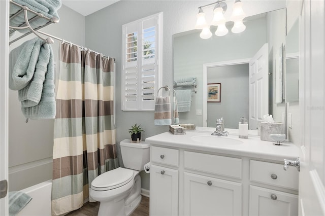 full bathroom featuring hardwood / wood-style flooring, shower / tub combo with curtain, vanity, and toilet