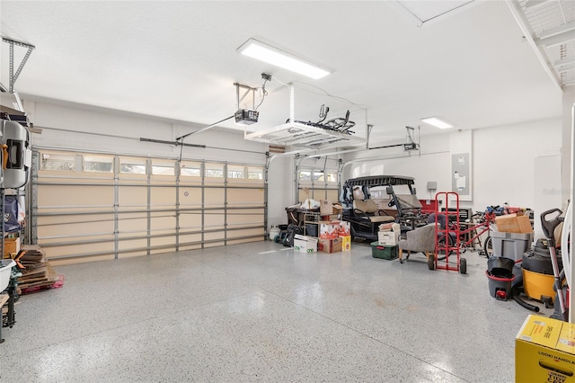 garage featuring electric panel and a garage door opener