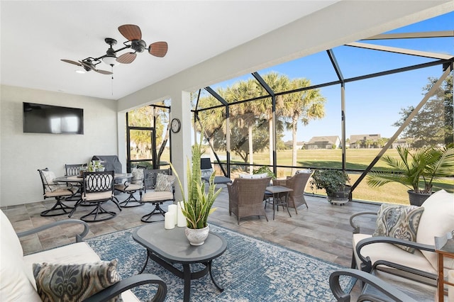 sunroom / solarium featuring ceiling fan