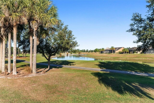 view of home's community with a yard and a water view