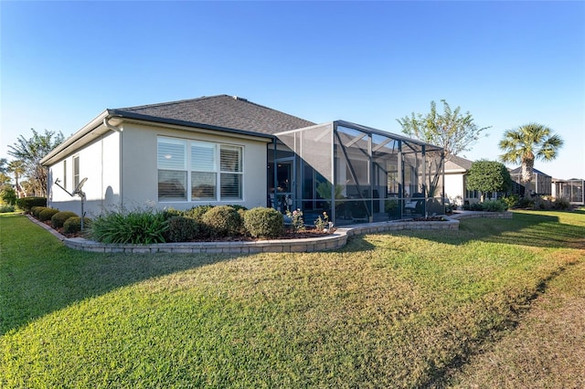 back of house featuring a lanai and a yard