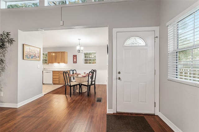 entryway with a chandelier and dark hardwood / wood-style flooring