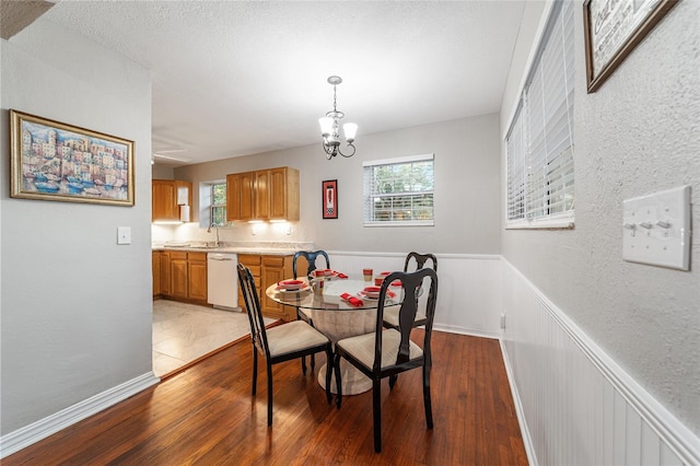 dining area featuring a notable chandelier and dark wood-type flooring