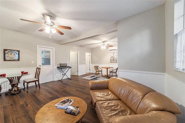 living room with ceiling fan, beam ceiling, and dark wood-type flooring