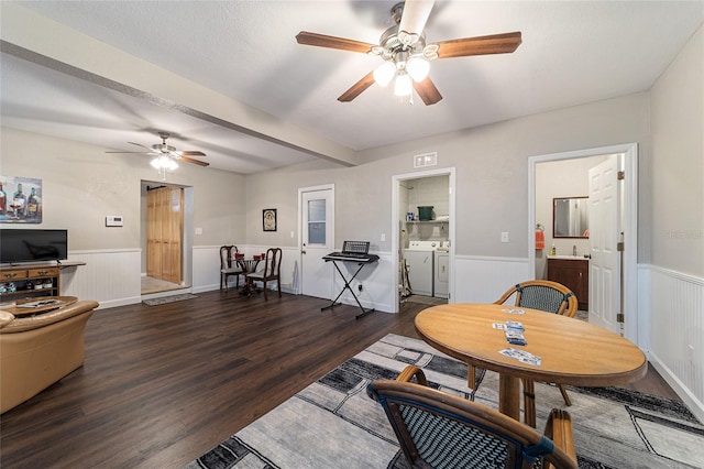 living room with separate washer and dryer, ceiling fan, and dark hardwood / wood-style floors