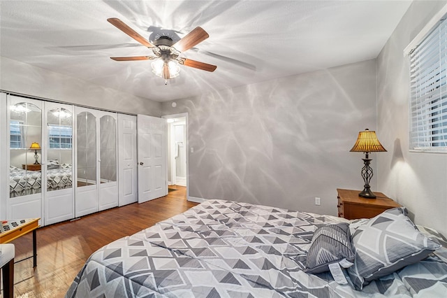 bedroom featuring hardwood / wood-style flooring, a closet, and ceiling fan