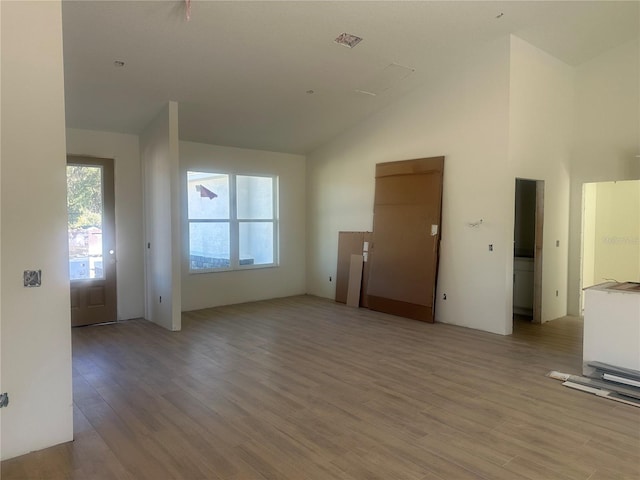 unfurnished living room with lofted ceiling and light hardwood / wood-style flooring