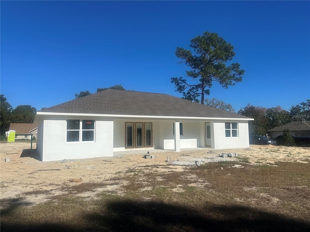 5912 NE 57th Loop N, Silver Springs, FL 34488 - rear view of house featuring roof with shingles and stucco siding
