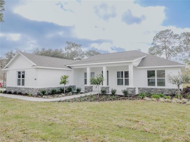 view of front of property with stone siding, stucco siding, a shingled roof, and a front lawn