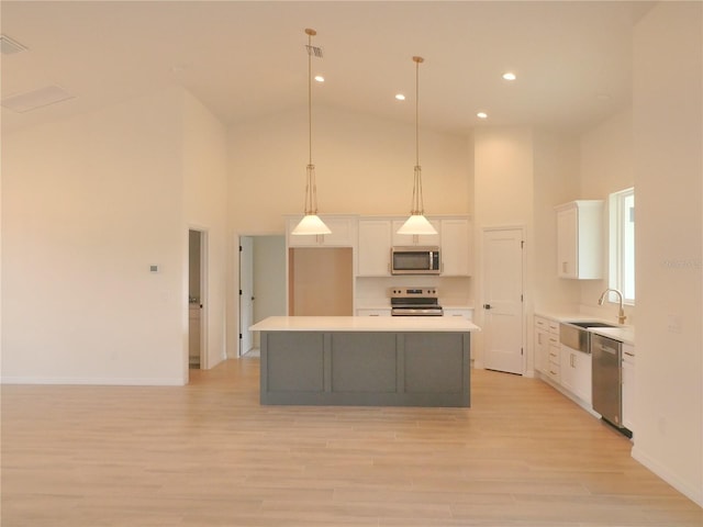 kitchen with white cabinetry, a center island, a sink, and stainless steel appliances