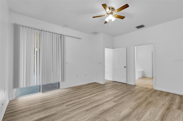 spare room featuring ceiling fan and light wood-type flooring